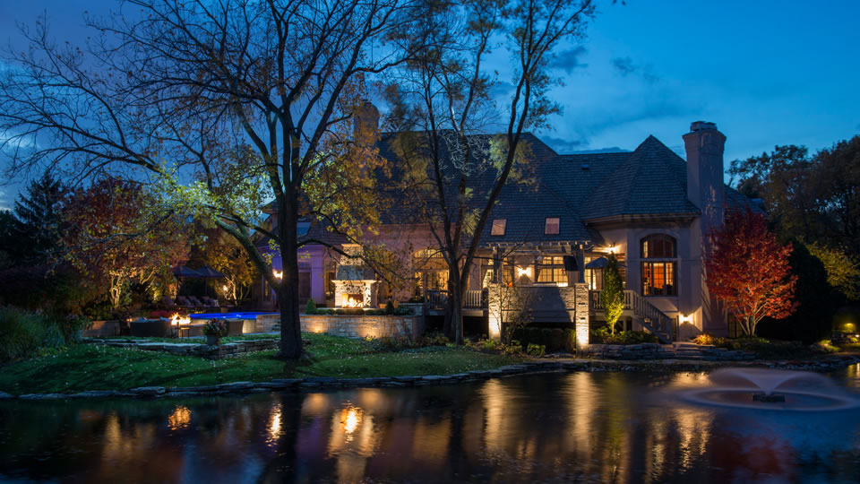 Picture of lighted backyard with pond